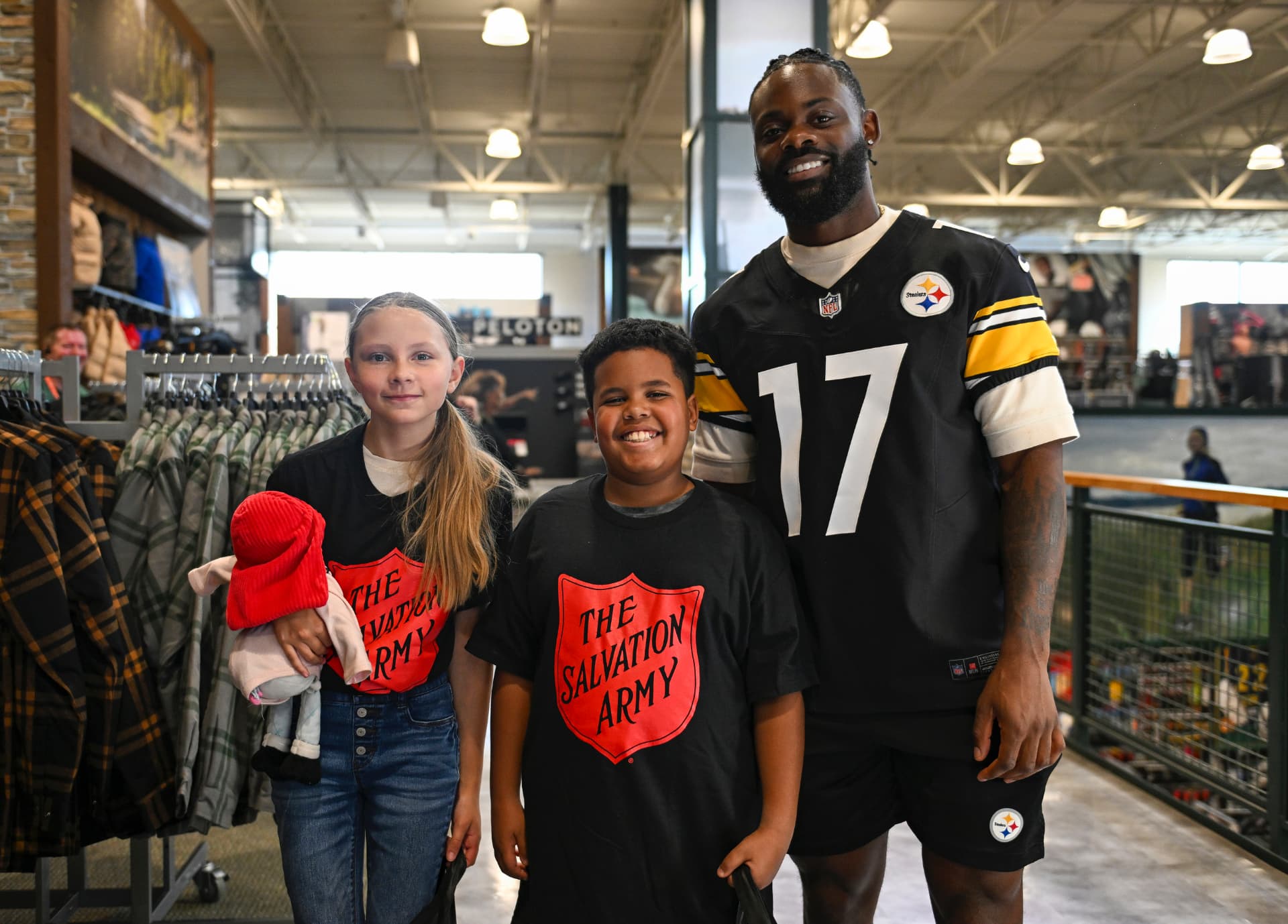 Ayo Oyelola with two young people during a Steelers community visit
